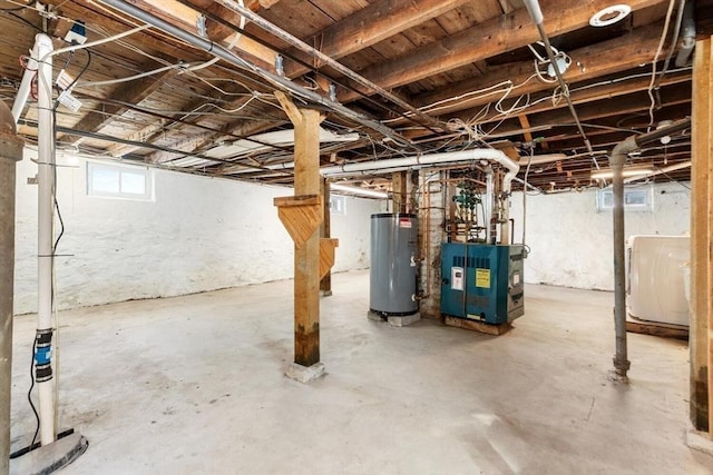 basement with a heating unit, washer / clothes dryer, and water heater