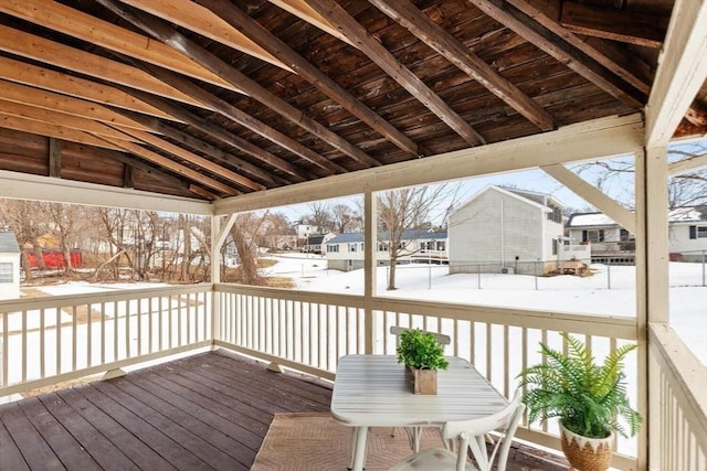 snow covered deck with a residential view