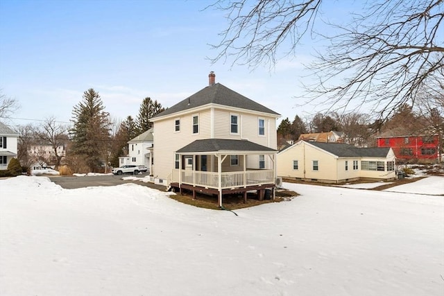 snow covered house with a chimney