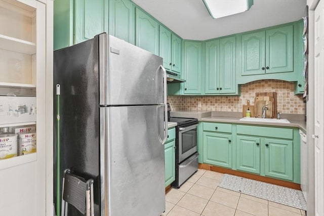 7 Thayer Pond Dr Unit 11, Oxford, MA 01537 - kitchen with appliances with stainless steel finishes, under cabinet range hood, light tile patterned floors, tasteful backsplash, and light countertops