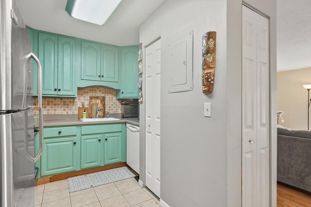 7 Thayer Pond Dr Unit 11, Oxford, MA 01537 - kitchen featuring freestanding refrigerator, tasteful backsplash, light countertops, white dishwasher, and light tile patterned floors