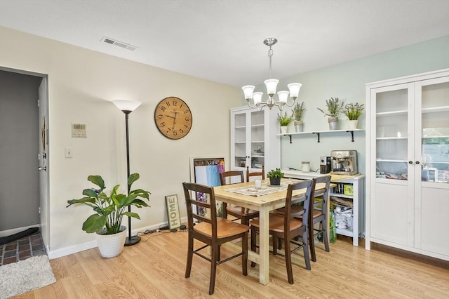 7 Thayer Pond Dr Unit 11, Oxford, MA 01537 - dining room with light wood-style flooring, a chandelier, and french doors