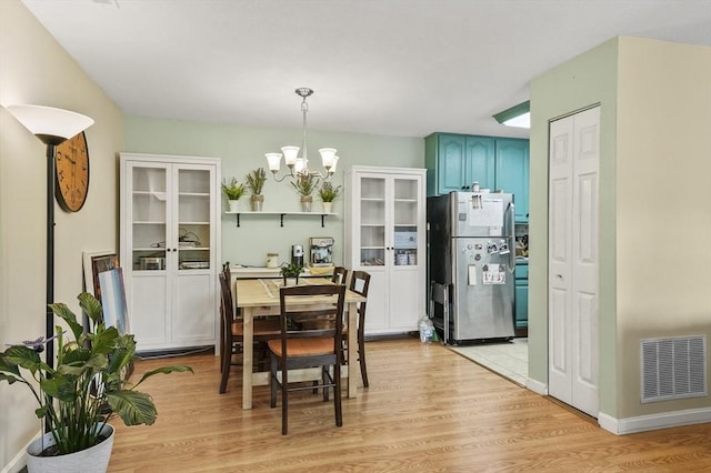7 Thayer Pond Dr Unit 11, Oxford, MA 01537 - dining space featuring a chandelier and light wood-type flooring