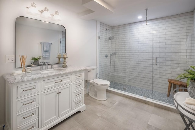 bathroom with a stall shower, tile patterned flooring, vanity, and toilet