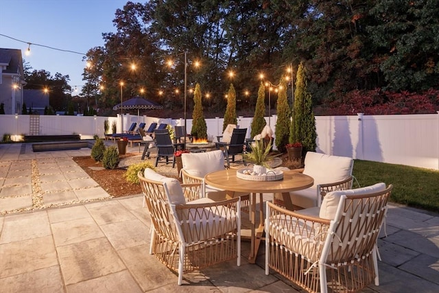 view of patio / terrace featuring outdoor dining area, a fenced backyard, and a fire pit