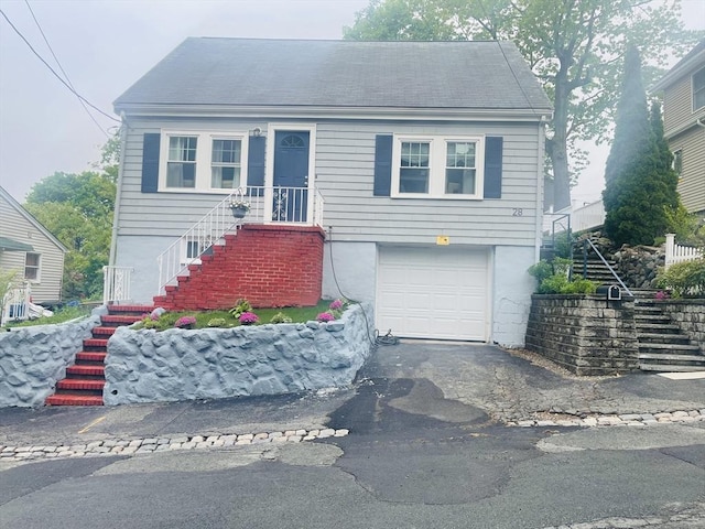 28 Roberts St, Malden, MA 02148 - view of front of home featuring stairs, a garage, and asphalt driveway
