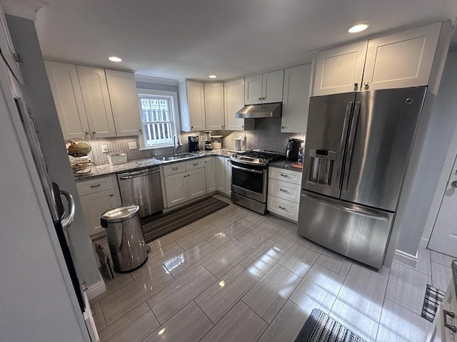 28 Roberts St, Malden, MA 02148 - kitchen featuring stainless steel appliances, under cabinet range hood, a sink, backsplash, and recessed lighting