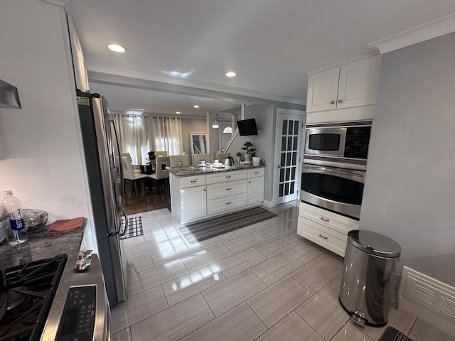 28 Roberts St, Malden, MA 02148 - kitchen featuring stainless steel appliances, white cabinetry, recessed lighting, a peninsula, and ornamental molding