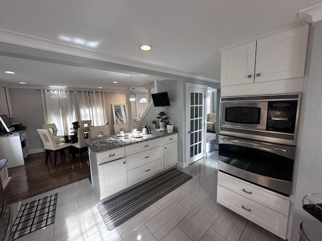 28 Roberts St, Malden, MA 02148 - kitchen featuring stainless steel appliances, white cabinets, dark stone countertops, recessed lighting, and baseboards