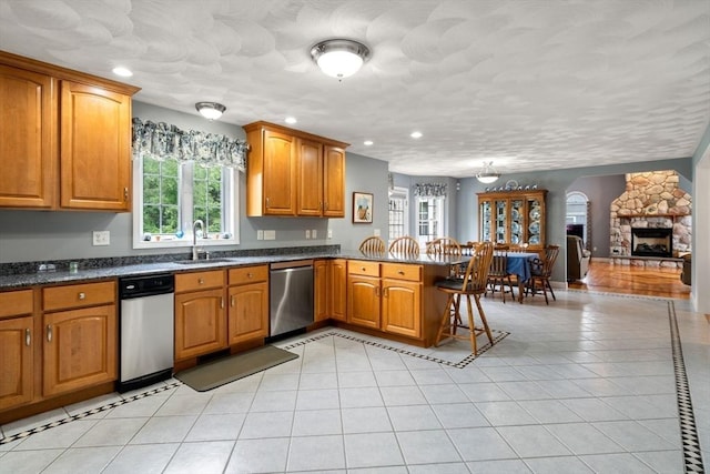 75 Birchwood Rd, Tewksbury, MA 01876 - kitchen featuring stainless steel dishwasher, a peninsula, healthy amount of natural light, brown cabinets, and recessed lighting