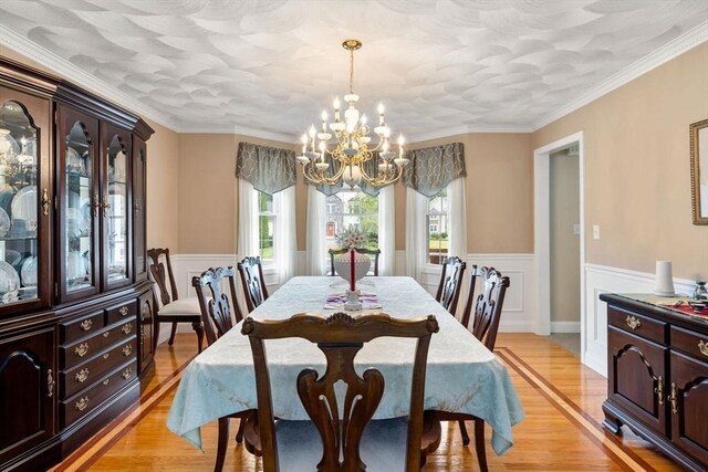75 Birchwood Rd, Tewksbury, MA 01876 - dining room featuring a chandelier, a wainscoted wall, light wood-style floors, and crown molding
