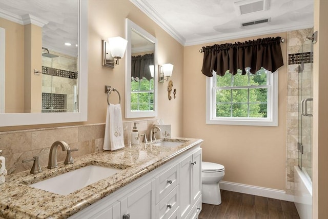 75 Birchwood Rd, Tewksbury, MA 01876 - bathroom with double vanity, ornamental molding, wood finished floors, and decorative backsplash
