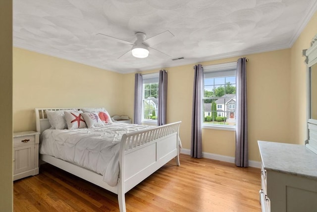 75 Birchwood Rd, Tewksbury, MA 01876 - bedroom featuring multiple windows, light wood-type flooring, and ceiling fan