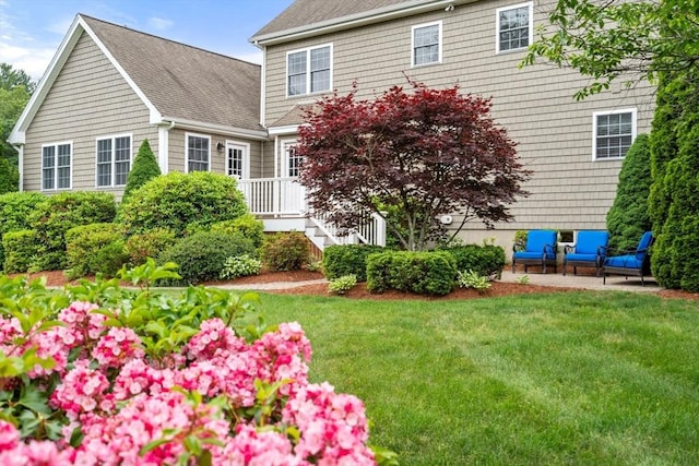 75 Birchwood Rd, Tewksbury, MA 01876 - back of property with a lawn, a shingled roof, and outdoor lounge area