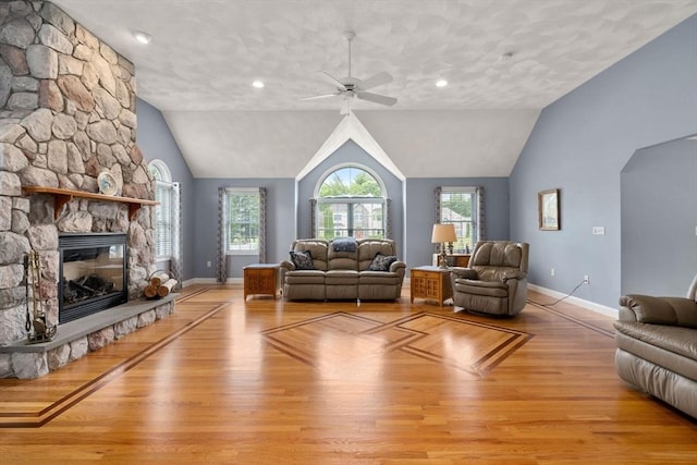 75 Birchwood Rd, Tewksbury, MA 01876 - living room featuring ceiling fan, a fireplace, wood finished floors, lofted ceiling, and arched walkways