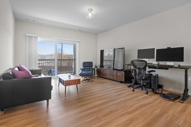 office space with baseboards and light wood-style floors