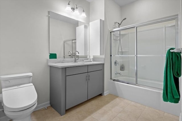 bathroom with tile patterned floors, toilet, baseboards, bath / shower combo with glass door, and vanity