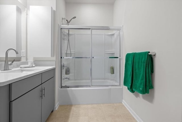 bathroom featuring tile patterned flooring, vanity, and shower / bath combination with glass door