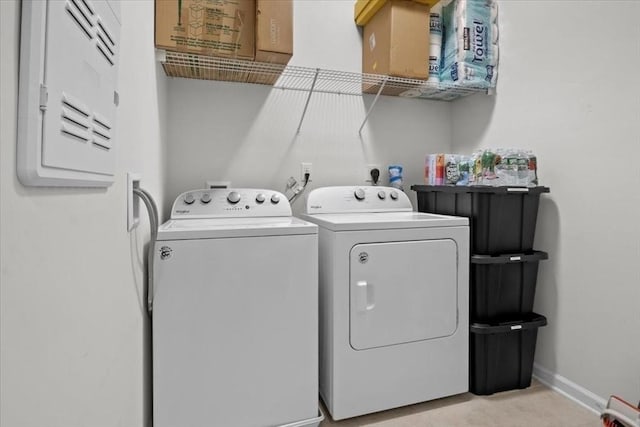 laundry area featuring washer and clothes dryer, laundry area, and baseboards