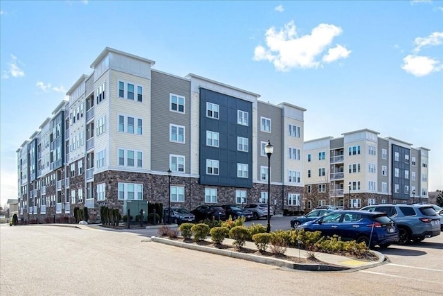 view of building exterior with uncovered parking