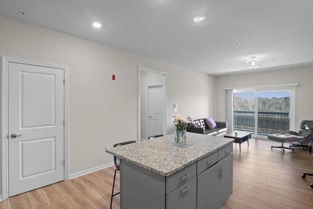 kitchen with light wood-style flooring, open floor plan, and gray cabinetry