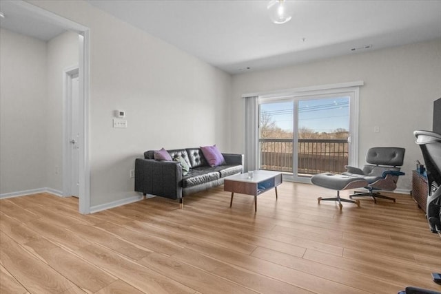 living room with light wood finished floors and baseboards