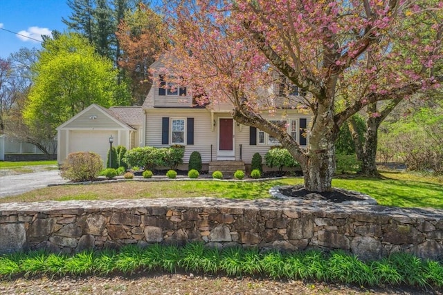 view of front of home with an attached garage, a front yard, and aphalt driveway