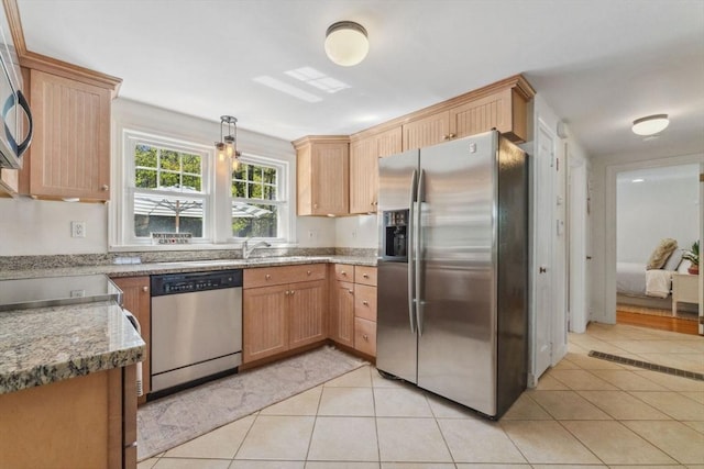 kitchen featuring appliances with stainless steel finishes and light tile patterned flooring