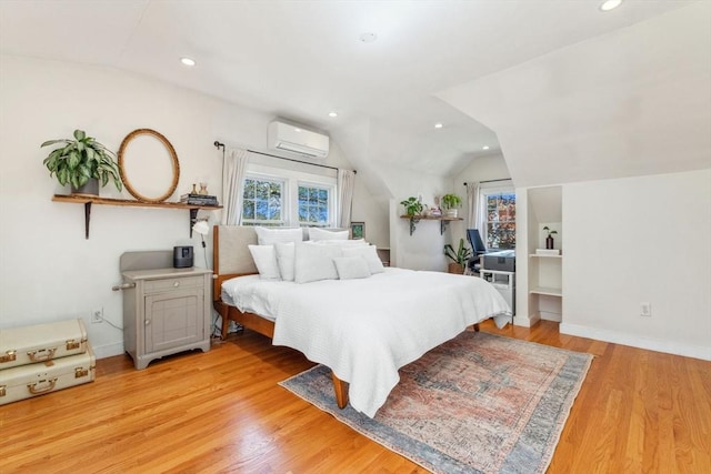 bedroom with recessed lighting, vaulted ceiling, multiple windows, and light wood finished floors