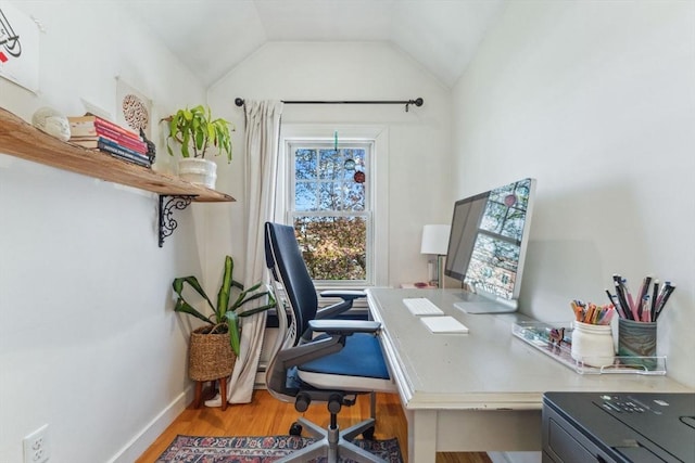 home office featuring baseboards, light wood-type flooring, and lofted ceiling
