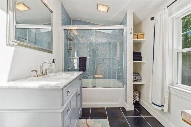 bathroom with tile patterned flooring, lofted ceiling, bath / shower combo with glass door, and vanity