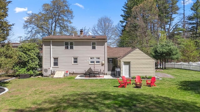 rear view of house featuring a patio area, fence, a yard, and a chimney