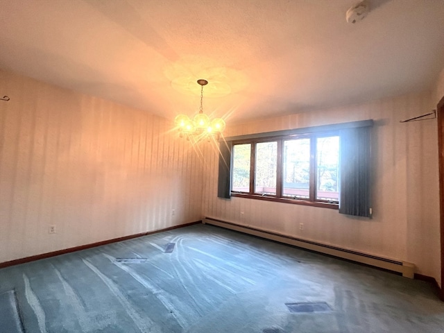 carpeted spare room featuring an inviting chandelier and a baseboard radiator