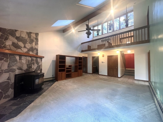 living room featuring carpet flooring, baseboard heating, ceiling fan, high vaulted ceiling, and a wood stove