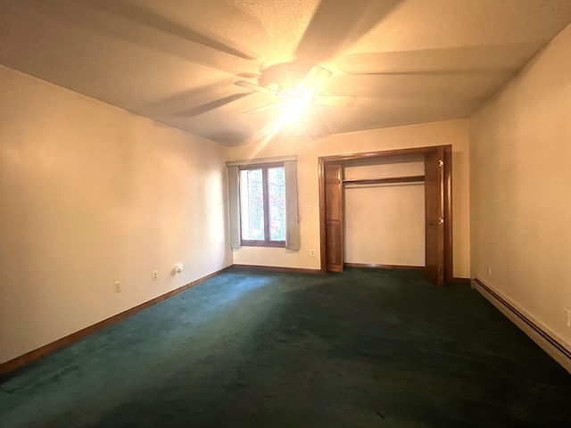 unfurnished bedroom featuring ceiling fan, a closet, dark carpet, and a baseboard heating unit