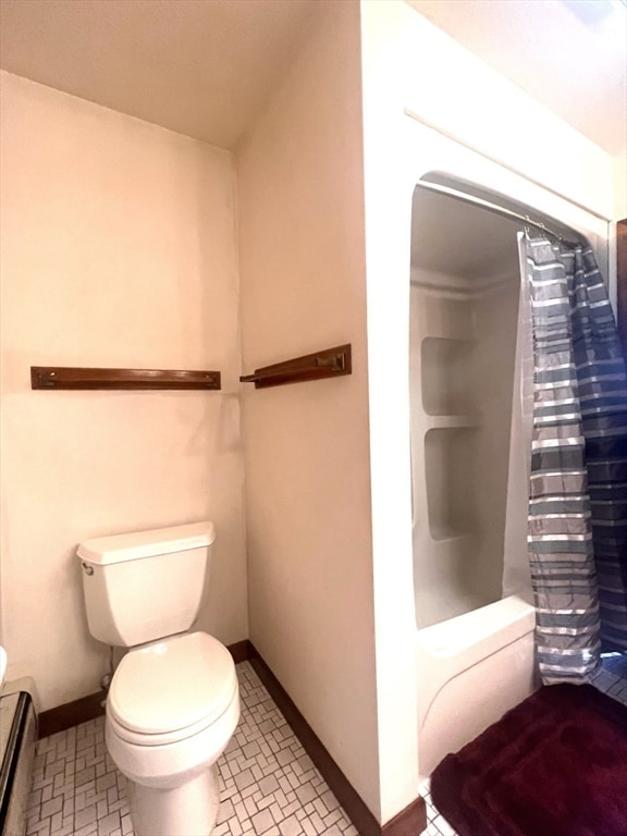 bathroom with tile patterned floors, a baseboard radiator, and toilet