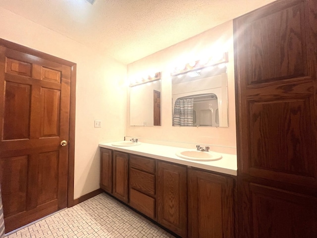 bathroom with vanity and a textured ceiling