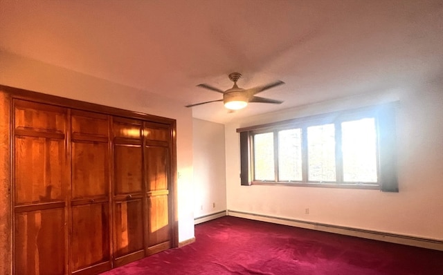 unfurnished bedroom with dark colored carpet, a closet, ceiling fan, and a baseboard heating unit