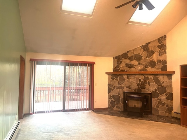 unfurnished living room with carpet flooring, lofted ceiling, a wood stove, and a baseboard heating unit