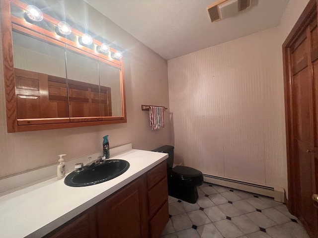 bathroom with vanity, a baseboard radiator, and toilet