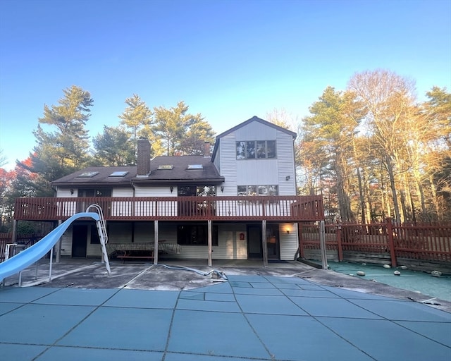 back of house with a deck and a patio area