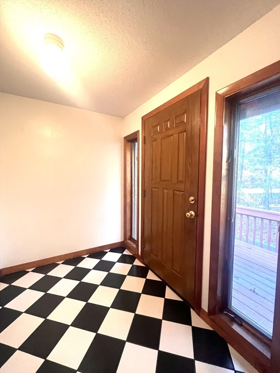 entryway with a textured ceiling