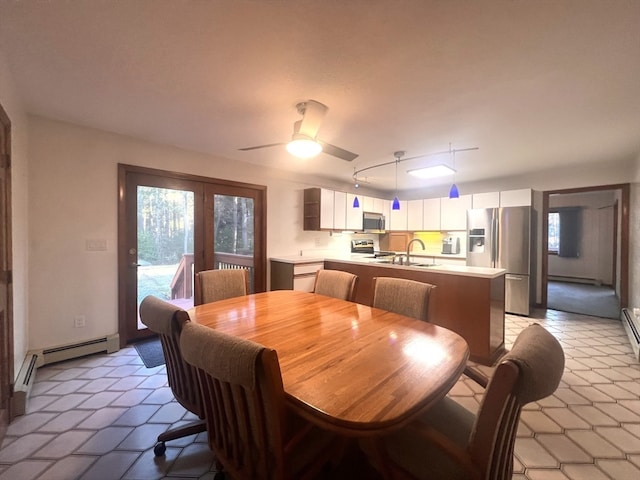 dining room with ceiling fan and sink