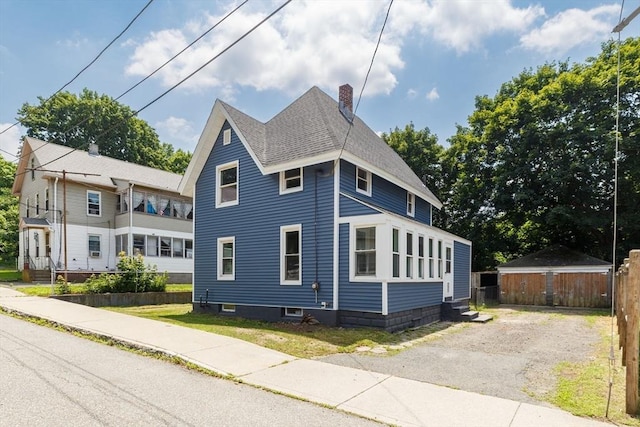 3 Aspen Ct, Ware, MA 01082 - view of property exterior with a chimney, a shingled roof, entry steps, and an outbuilding