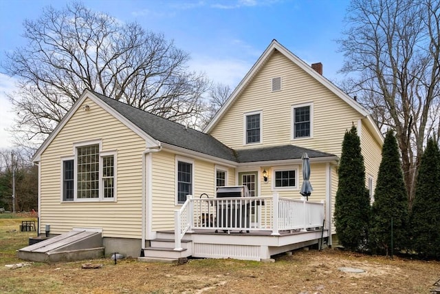 back of property featuring a wooden deck