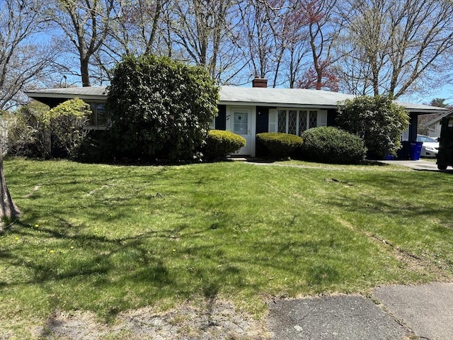 single story home featuring a chimney and a front yard