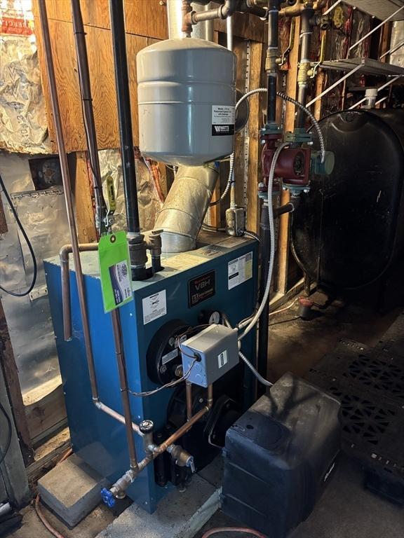 utility room with heating fuel and a heating unit