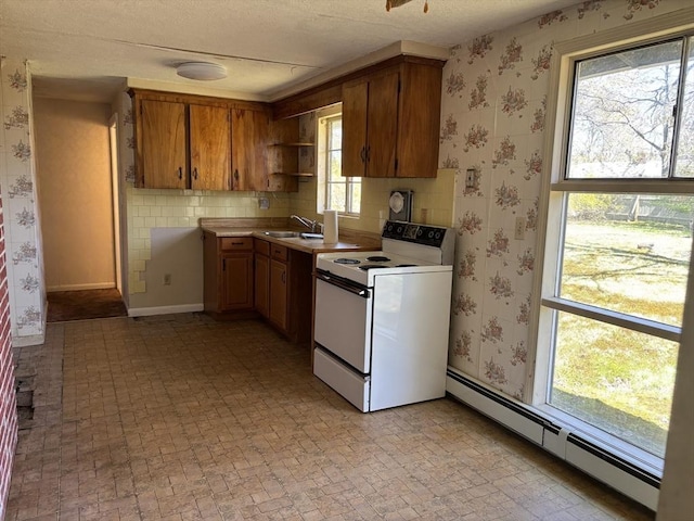 kitchen featuring electric stove, open shelves, baseboard heating, and a wealth of natural light