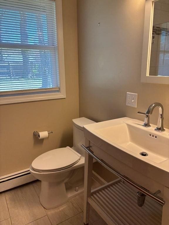 bathroom with vanity, a baseboard radiator, and toilet