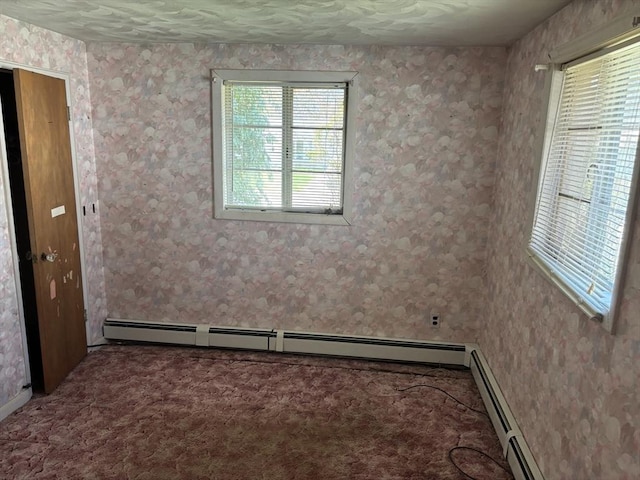 carpeted spare room featuring wallpapered walls and a baseboard radiator